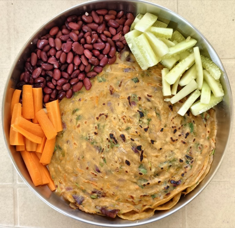 Sample meal plate from Deepa's nutrition plan, stuffed paratha with rajma, carrot sticks, and cucumber