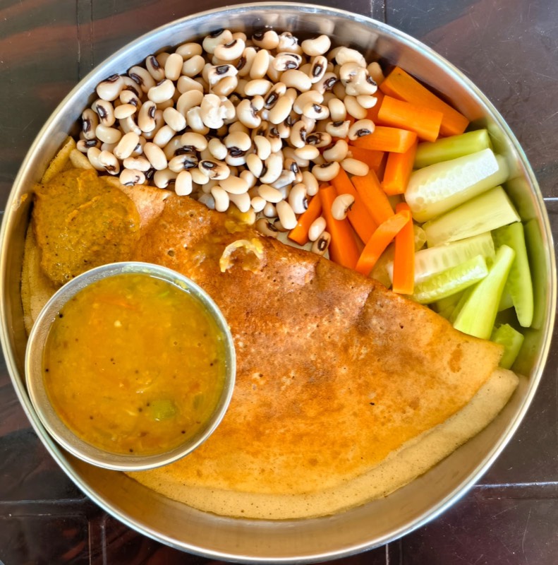 Another meal plate, ragi dosa with chutney, black-eyed peas, sambar, and fresh vegetables