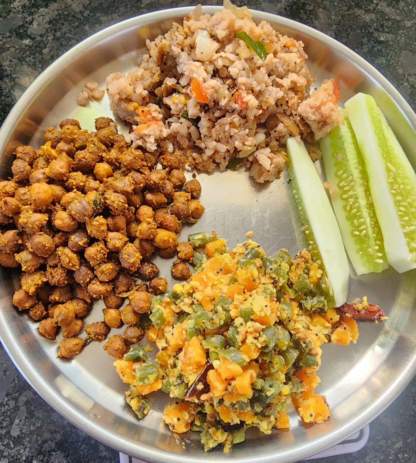 A typical portion-controlled plate from the program: ragi upma, chana, mixed vegetable poriyal, and cucumber