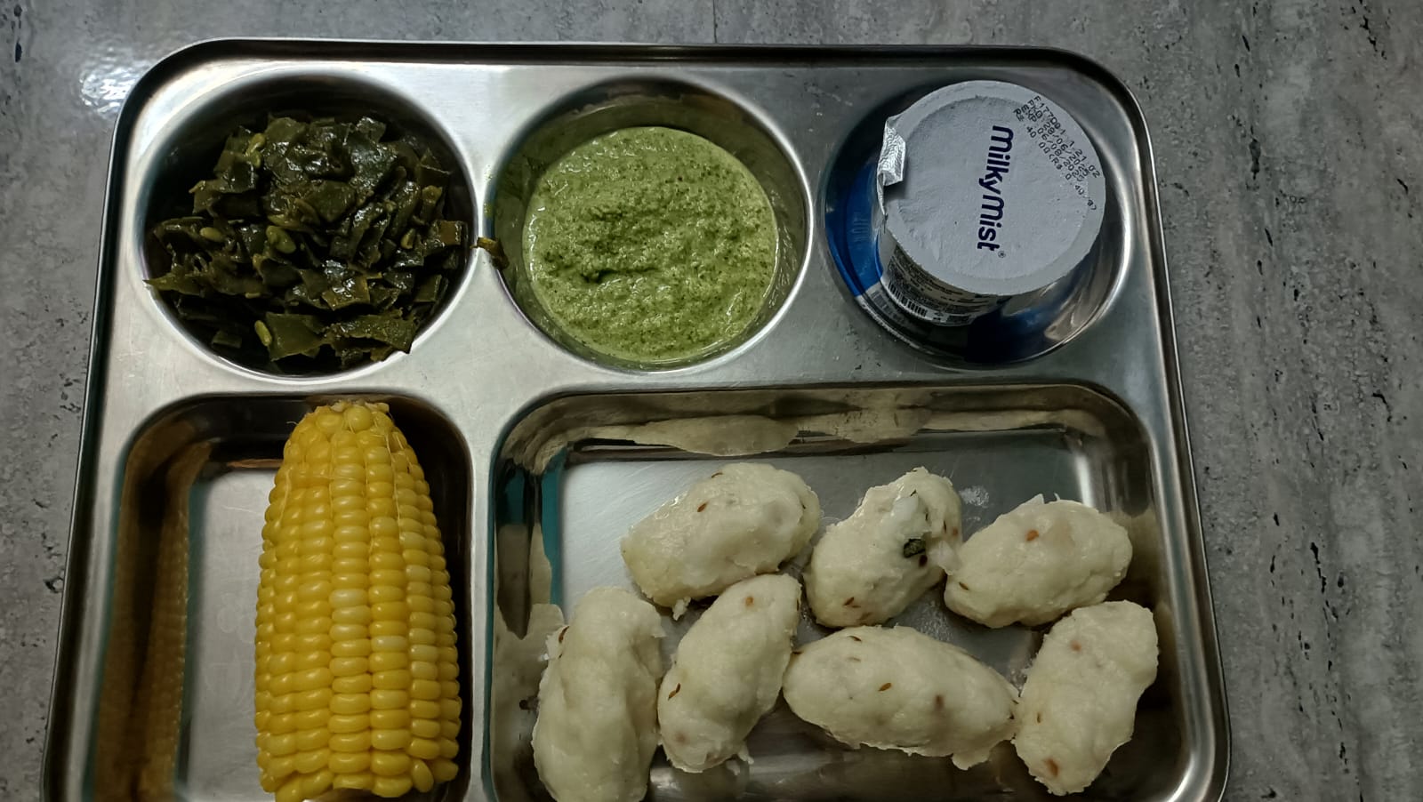A balanced meal of rice with grilled fish, an egg, sautéed cabbage, and fish curry, a calorie-dense protein-rich plate designed to support her recovery from underweight