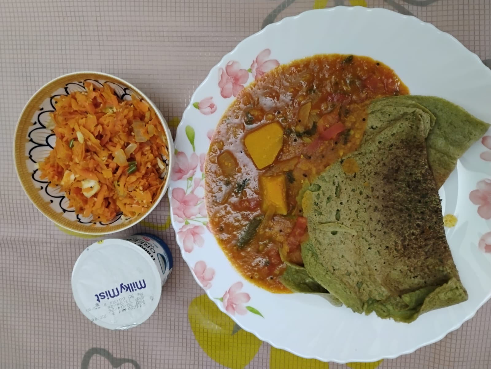 A balanced plate from Kalai and Ganesh's plan: millet dosas with sambar, carrot salad and greek yogurt