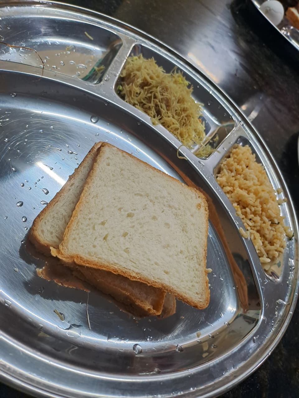 A typical hostel mess plate: white bread slices, vermicelli and rice, the kind of carbohydrate-heavy meal Arthi's plan had to work around