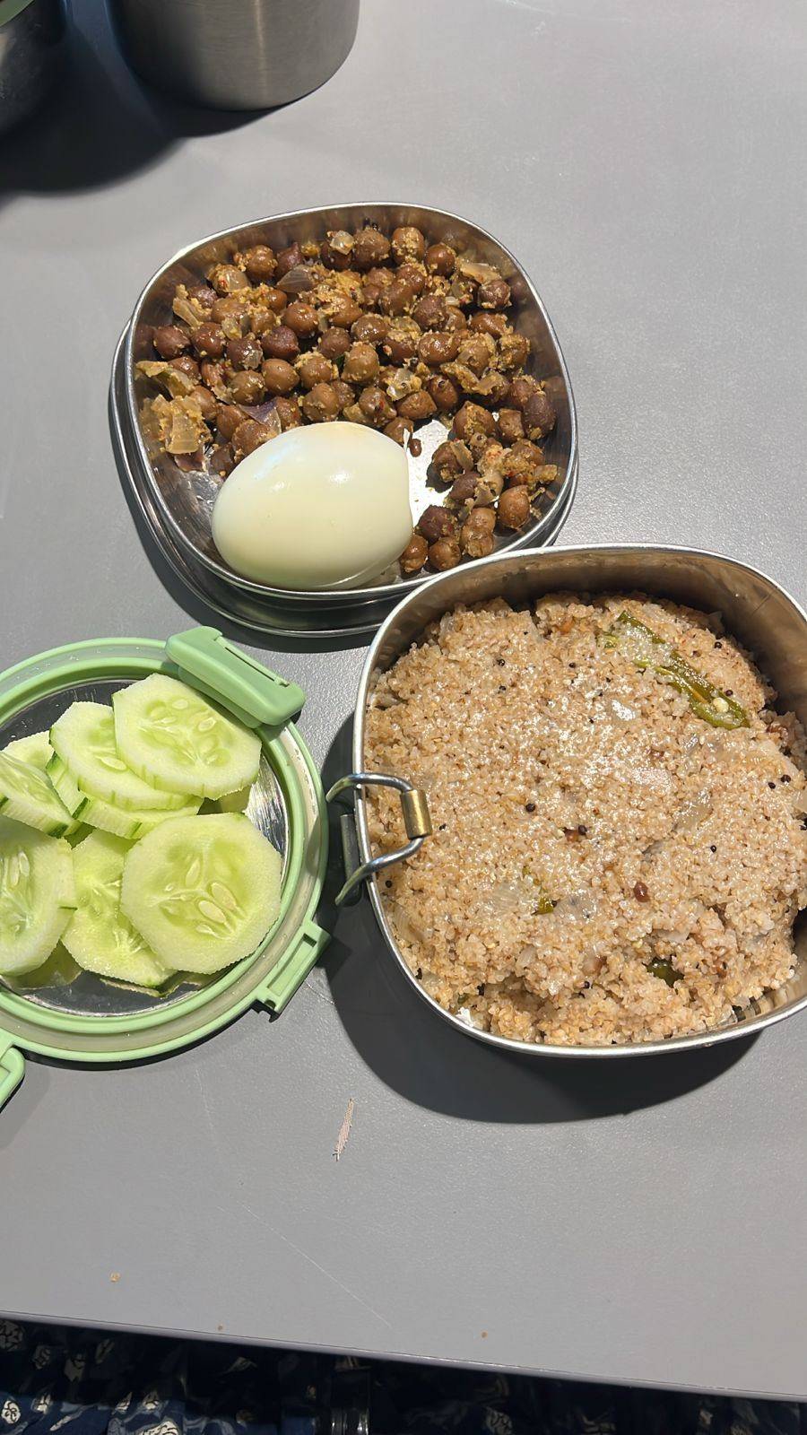 A packed work meal from the plan: black chana sundal with a boiled egg, cucumber slices and seasoned broken-wheat upma