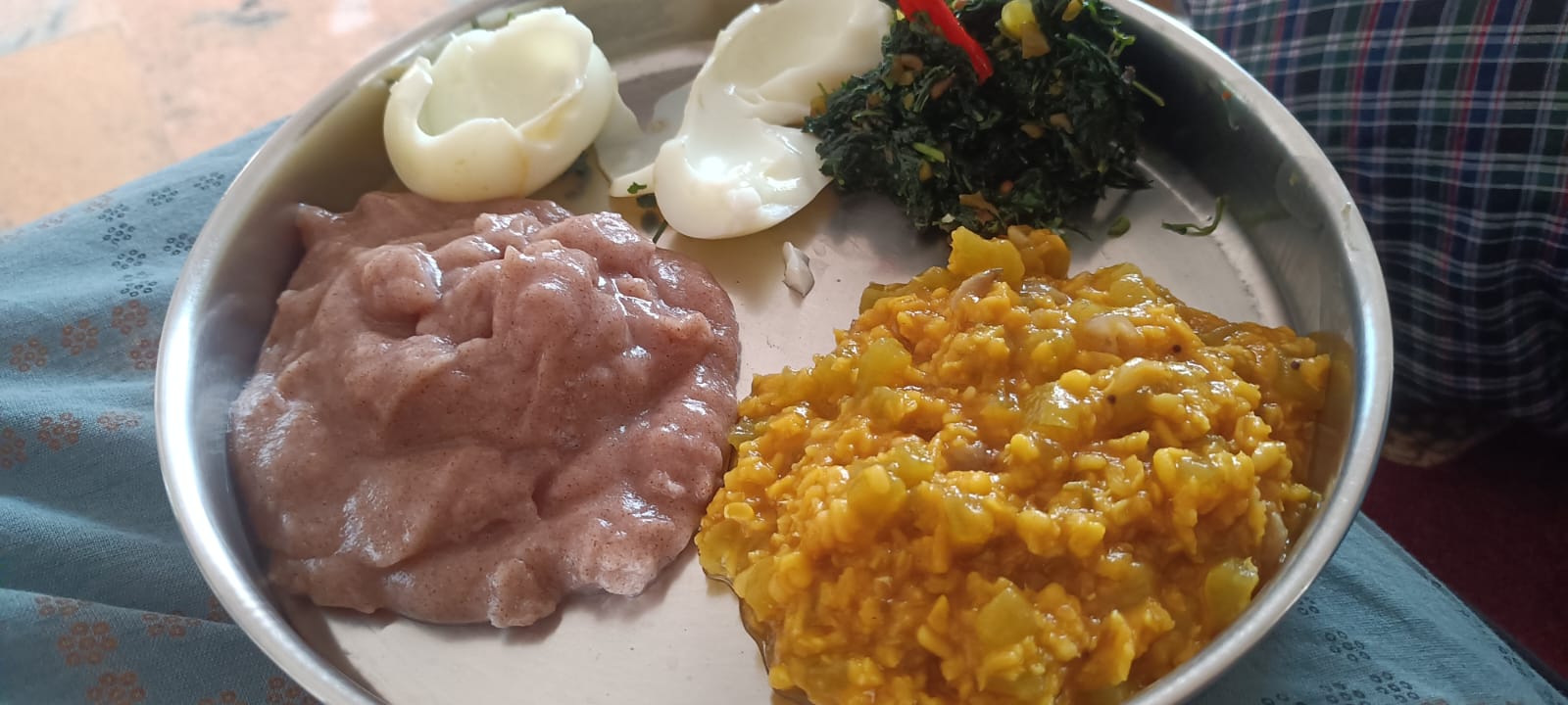 A balanced plate of ragi kali with a vegetable dal, boiled egg whites, and a greens poriyal