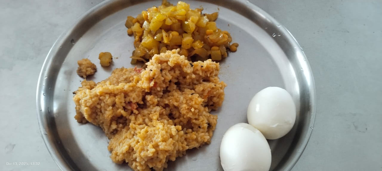 Sujatha's hostel meal, rice with sabzi from the hostel mess, plus two boiled eggs made in her room kettle