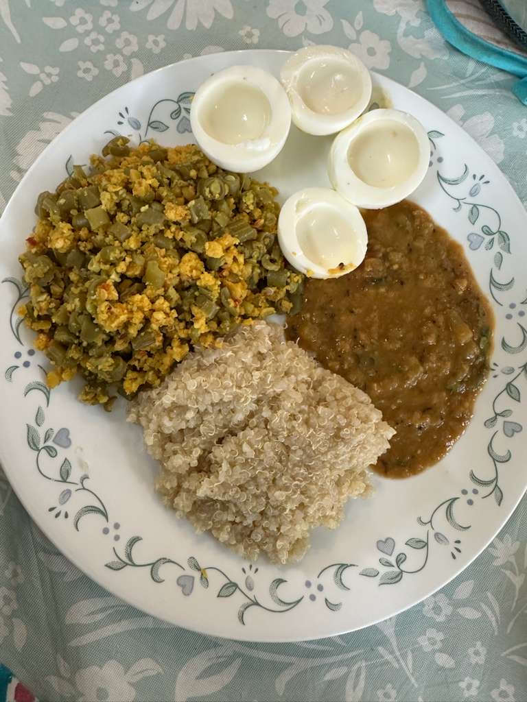 A balanced plate with a beans and egg poriyal, boiled egg whites, a dal, and a portion of cooked grains