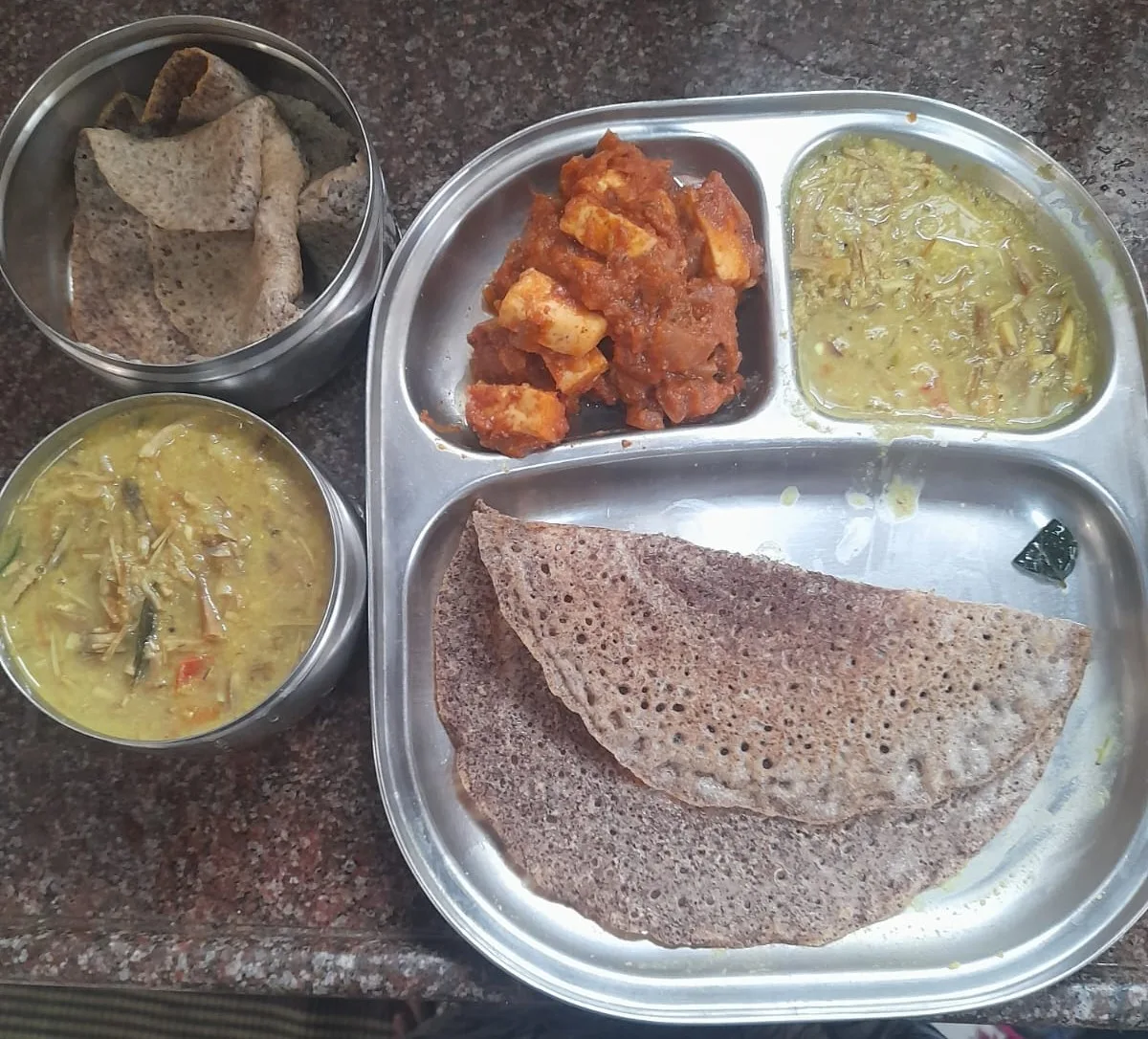 A balanced meal box: ragi dosa, paneer, and a vegetable kootu