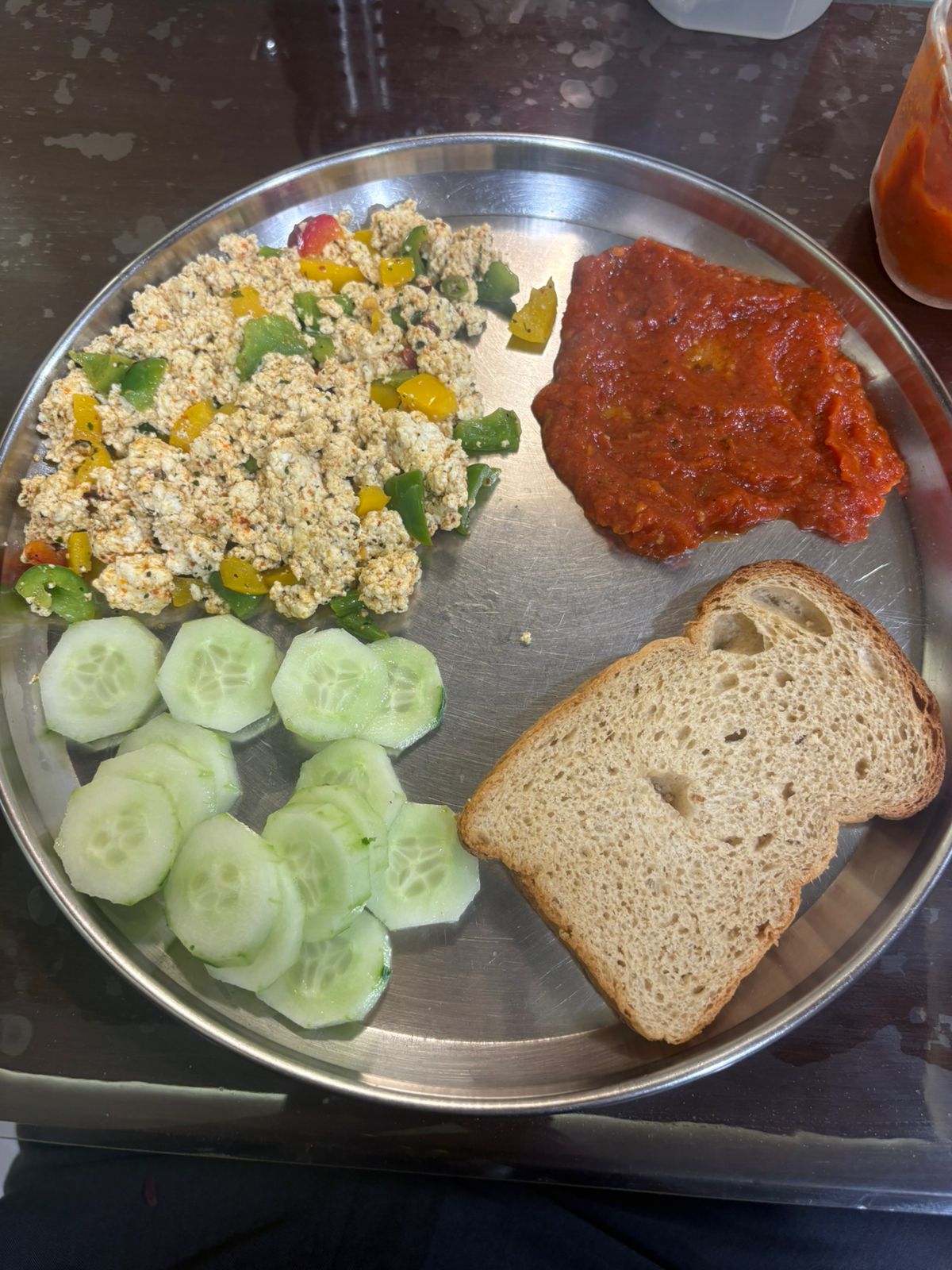 One of Mithra's plates: paneer bhurji, cucumber and a slice of brown bread