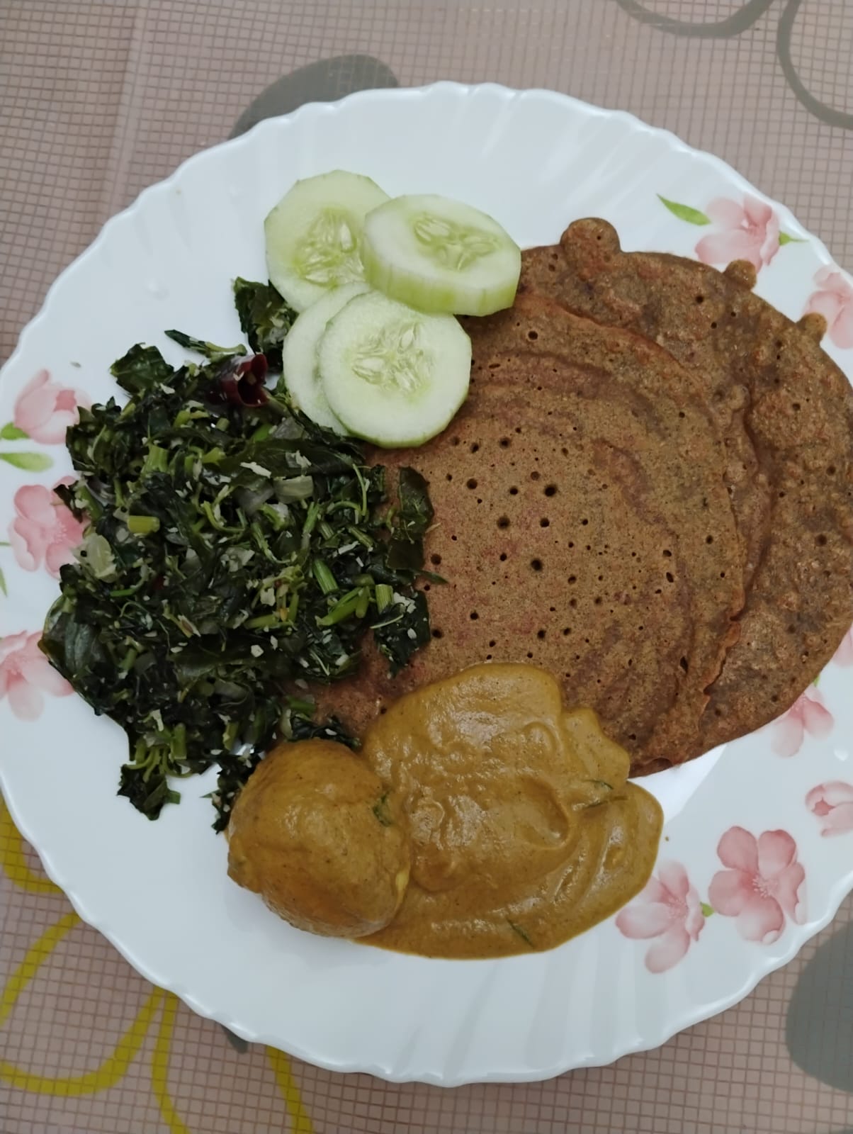 One of Kavya's balanced plates: ragi dosa, greens, kootu and cucumber